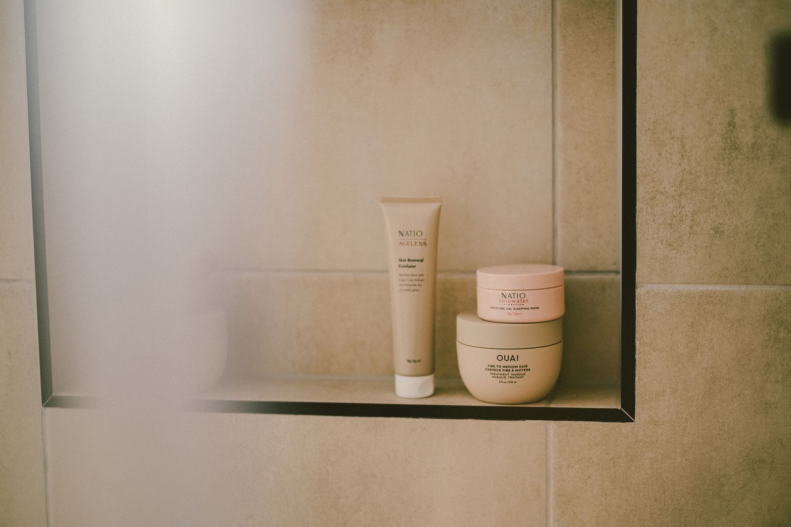 Beauty and self-care products neatly arranged on a bathroom shelf